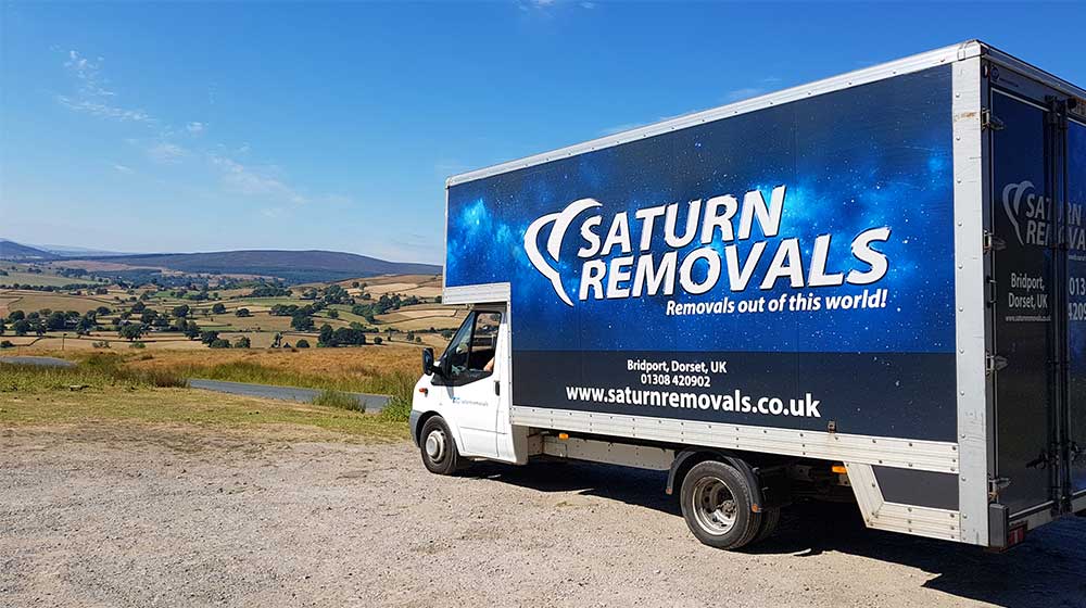 Saturn Removals van in the countryside